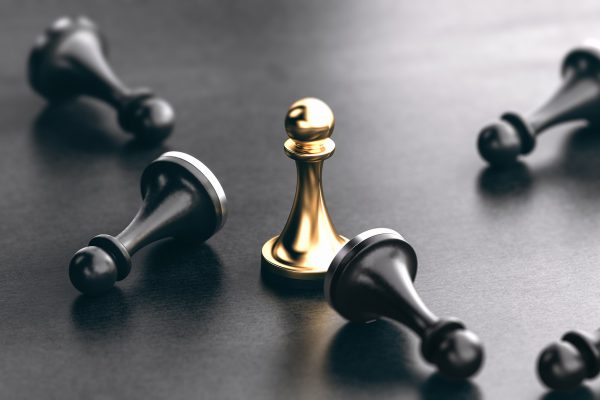 3D illustration of fallen black pawns and a golden one standing up. Concept of competitors marketing or business strategy.